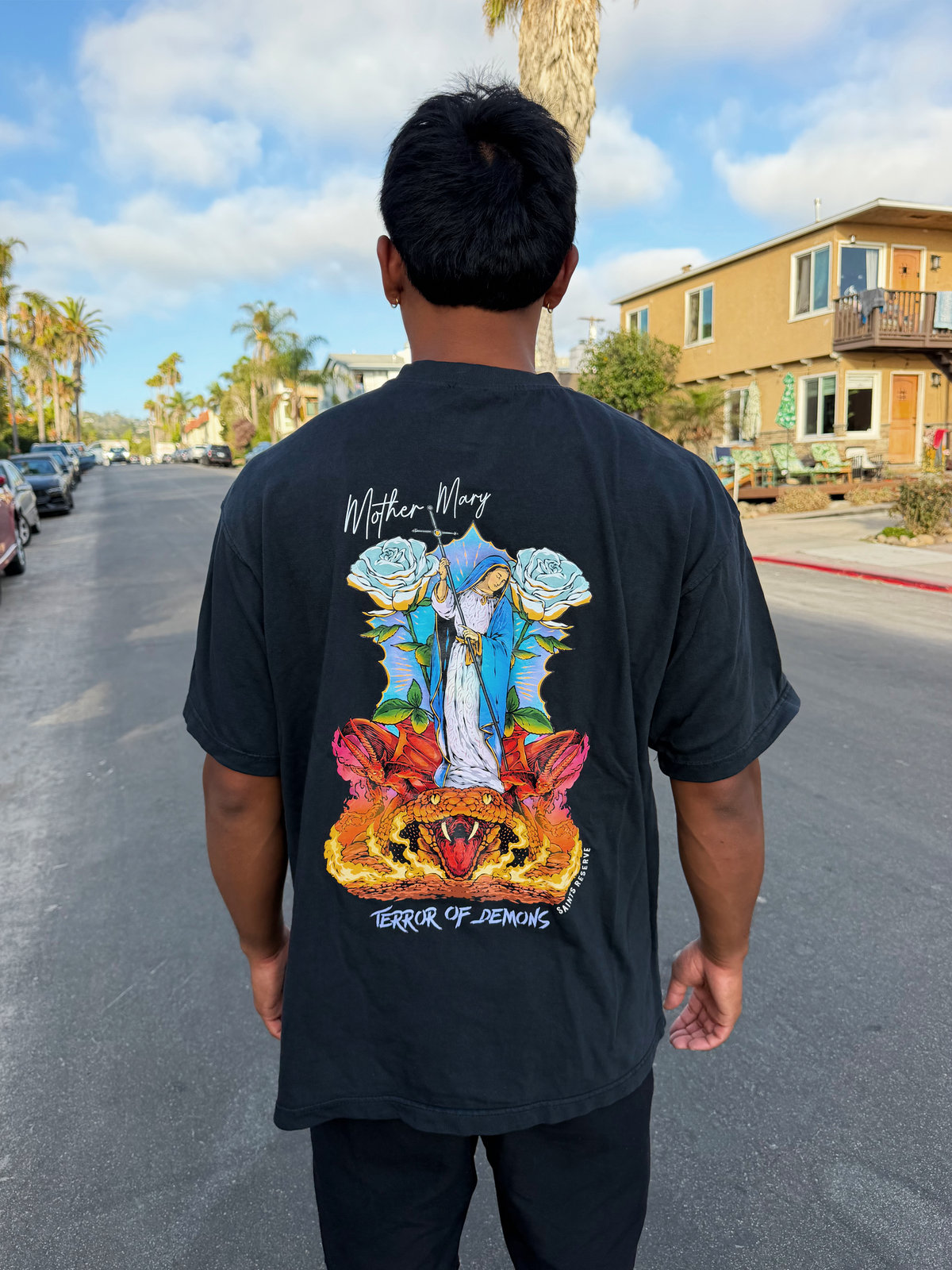The Mother Mary Terror of Demons shirt on a street by the beach